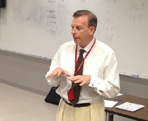 Dr. Joe Arminio presenting at a whiteboard during a lecture