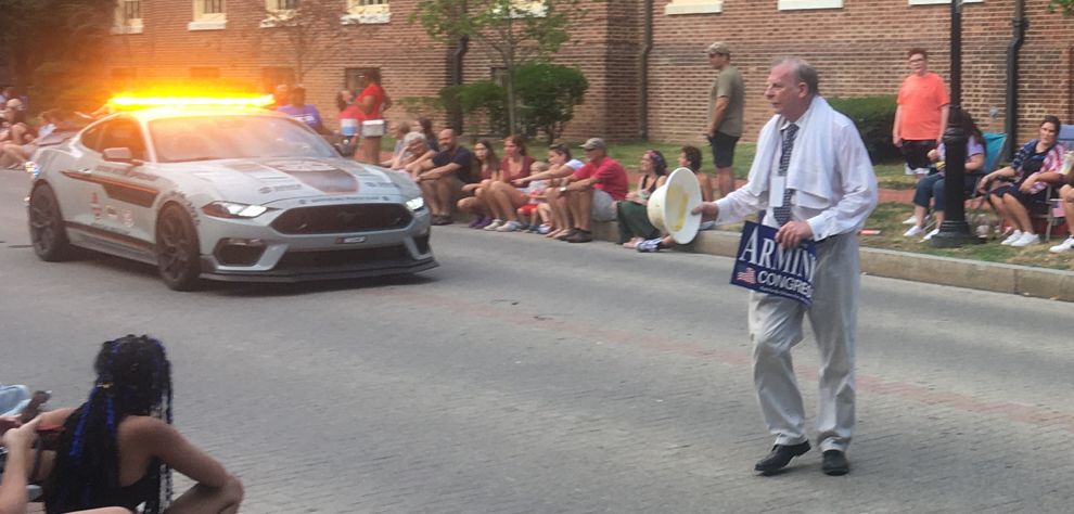 Dr. Joe Arminio campaigning at the Dover 2024 parade, carrying an Arminio for Congress sign
